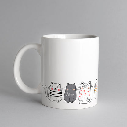 Cute cats stand on a mug