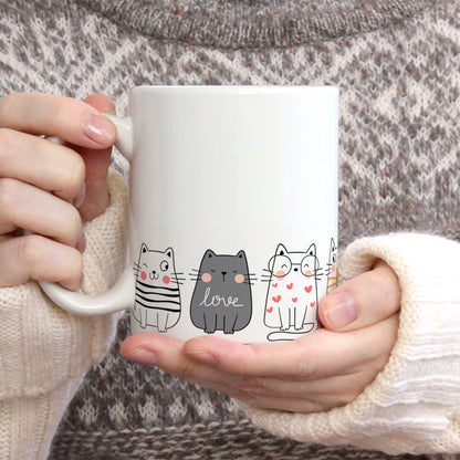 Cute cats stand on a mug